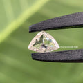 Curve trillion cut lab grown diamond displaying F color and VS2 clarity in a close-up view