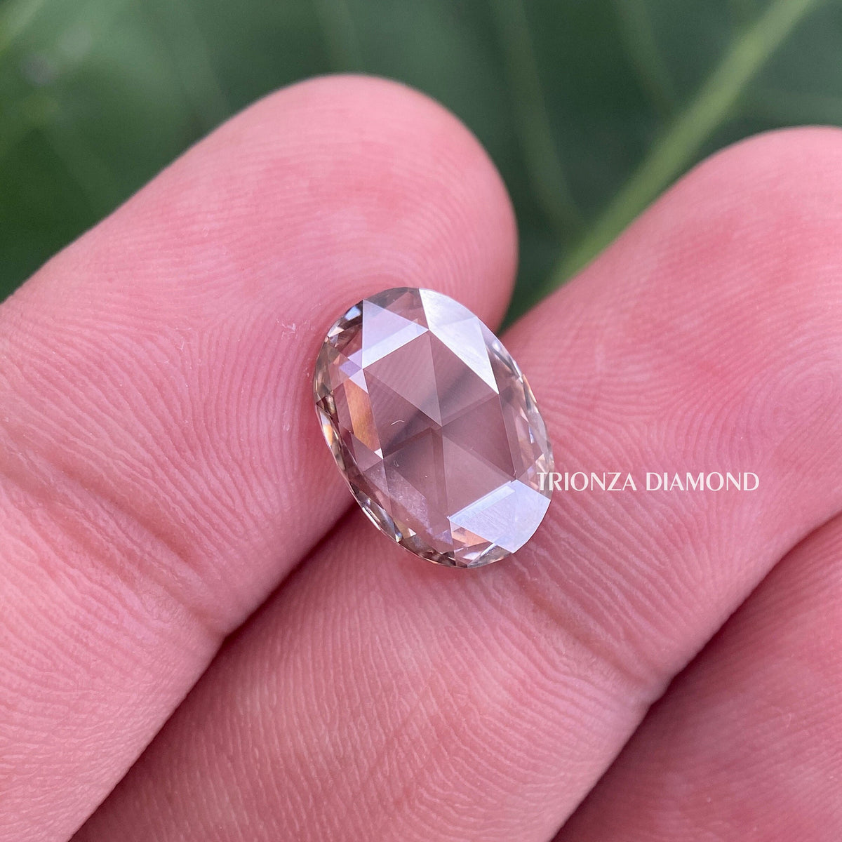 Loose oval diamonds arranged together showing their matching 2 ct each weight and brown hue