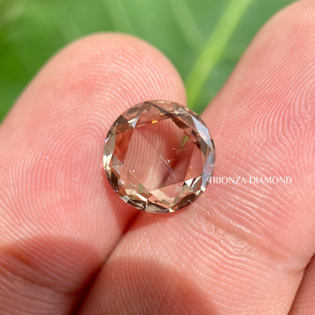 Round rose cut lab grown diamond displaying its intense brown color and vintage cut facets
