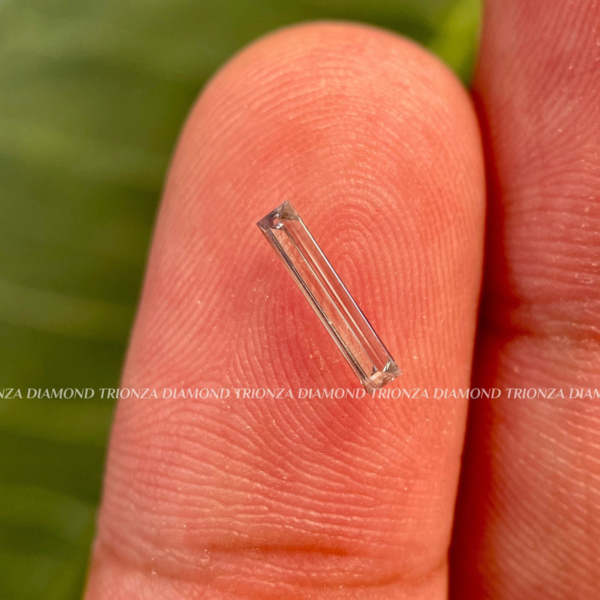 Elongated baguette cut lab grown diamond loose stone displayed to show its clarity and facets