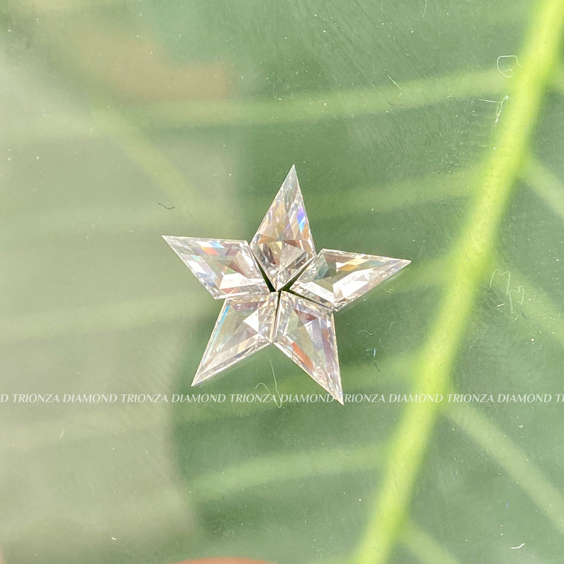 Kite cut star shape lab grown diamonds arranged to show the unique five stone pattern