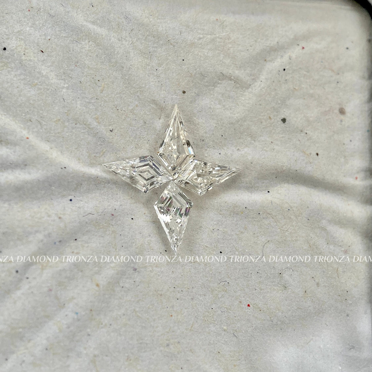 Close-up of the four kite cut diamonds showing their F color and VS1 clarity