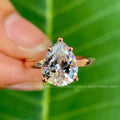 Vintage pear cut moissanite engagement ring crafted in 14K rose gold with prong setting