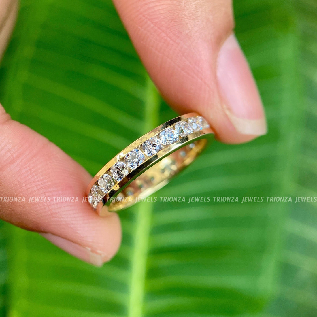 Channel set moissanite wedding band featuring round stones in a full eternity design