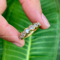 Half eternity band featuring round bezel set moissanite stones for everyday stacking