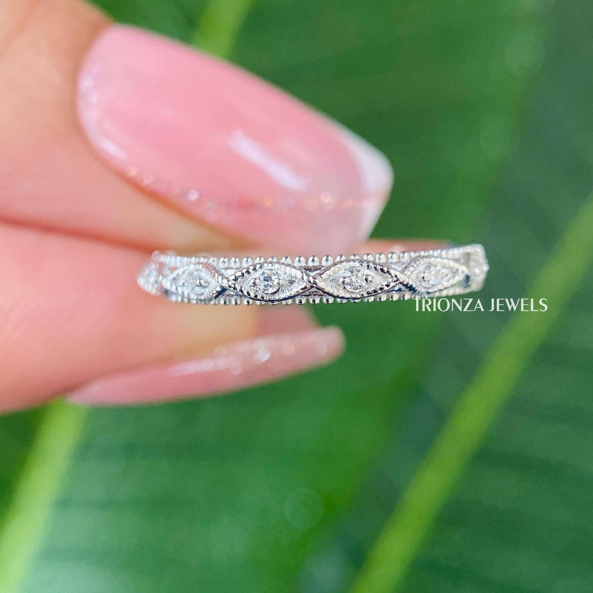 TrionzaDiamond wedding band showcasing prong set moissanite stones with vintage inspired milgrain edges