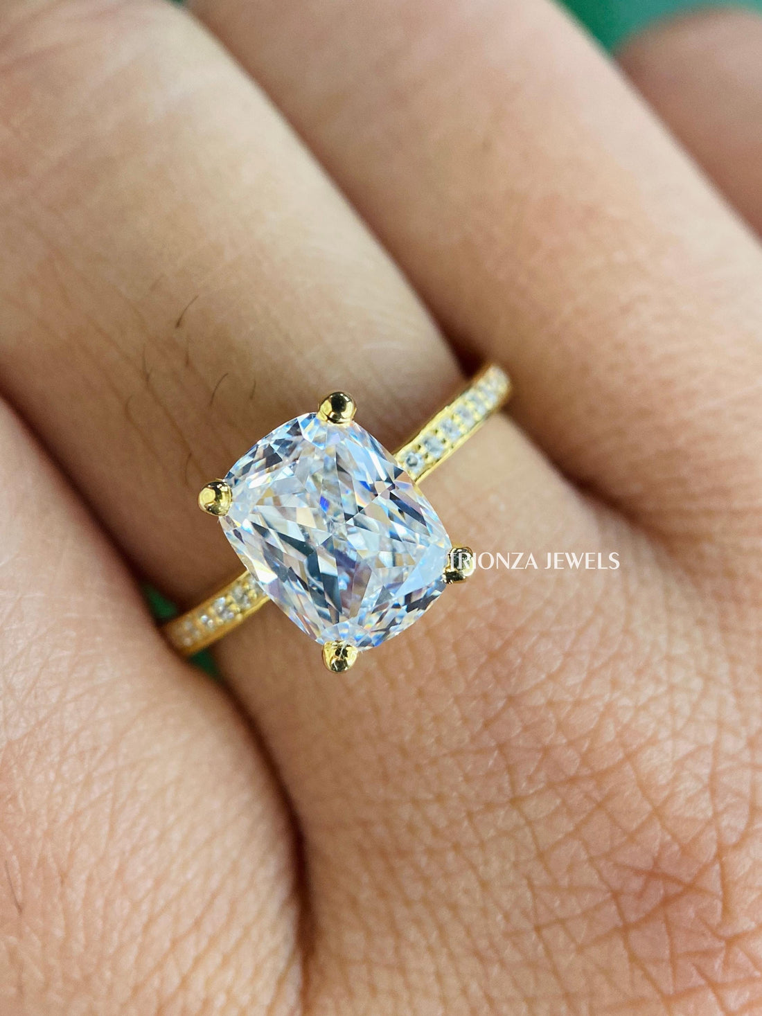 Elongated cushion cut moissanite engagement ring featuring a hidden halo and claw prong setting