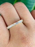 Close-up of the colorless moissanite baguettes set in a prong half eternity style