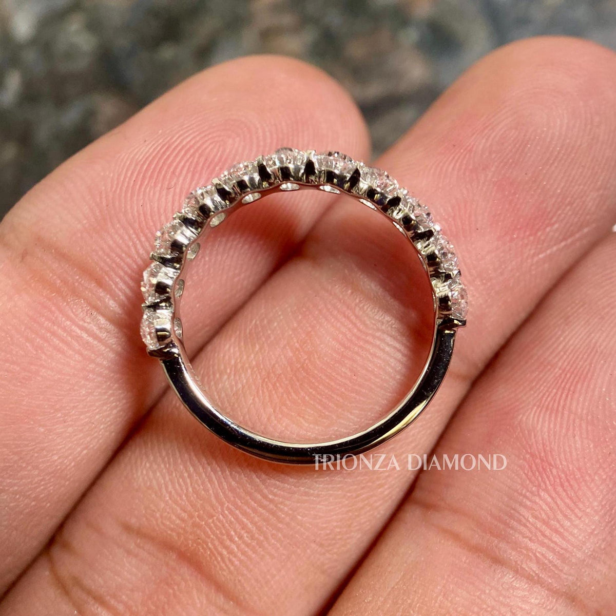 White gold half eternity band featuring DE/VS oval cut lab created diamonds