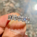 Oval cut lab grown diamond half eternity band displayed as a stackable wedding ring for her