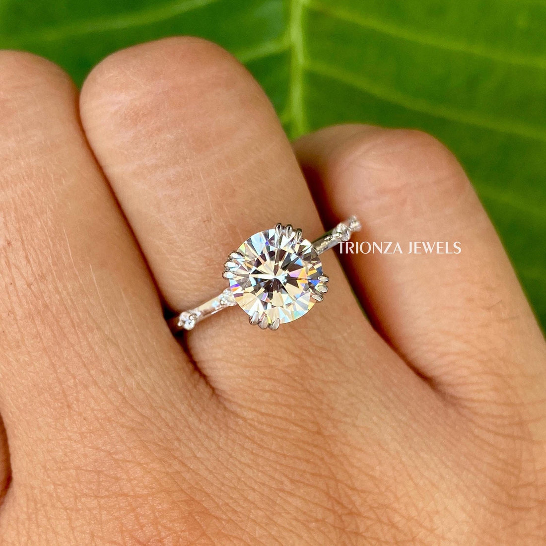 Vintage round cut moissanite engagement ring featuring a double prong solitaire setting