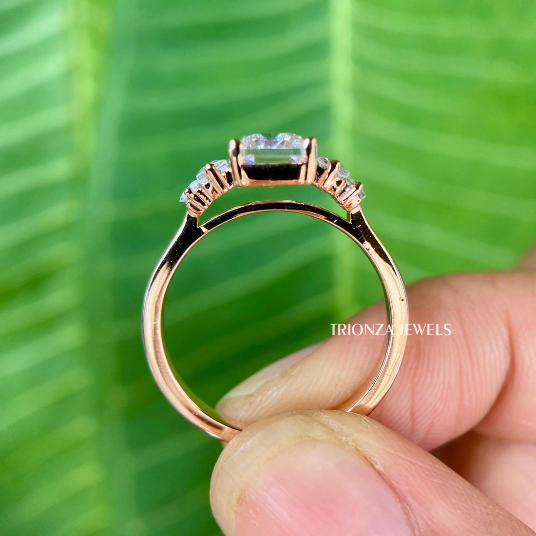 Emerald cut moissanite ring featuring a vintage five stone design in rose gold