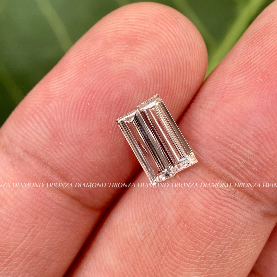 Long baguette cut lab grown diamond pair displayed to show F color and VS clarity