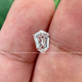 Shield cut loose diamond positioned to show facets and custom cut craftsmanship