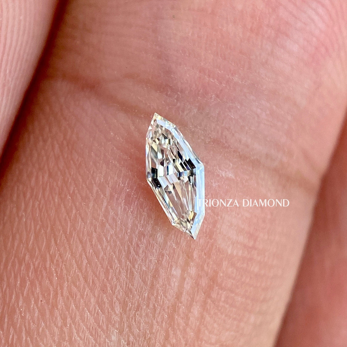 Marquise step cut lab grown diamond displayed to show its faceted brilliance and clarity