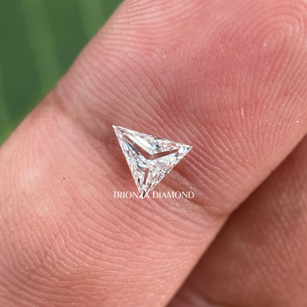 Close-up of the 0.32 CT trillion shape diamond highlighting its E color and VVS2 clarity