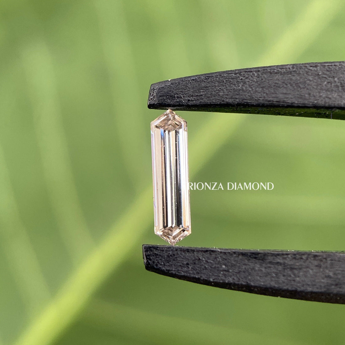 Elongated hexagon step cut lab grown diamond displayed to show its fancy faceted design