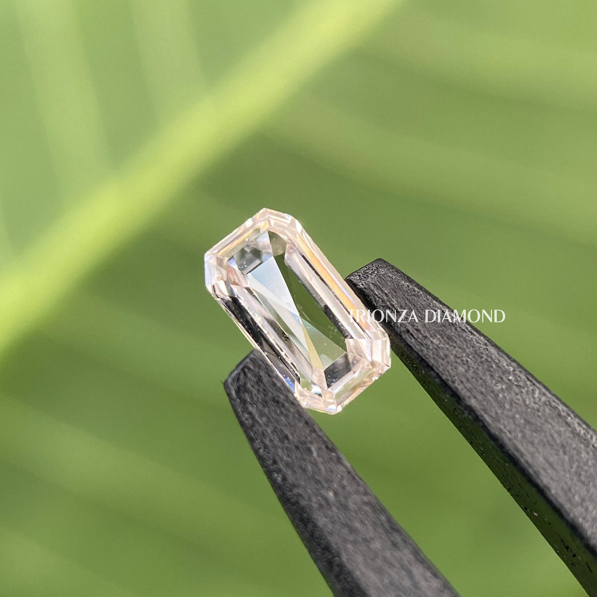 Emerald rose cut lab grown diamond displayed to show its unique faceted step cut pattern