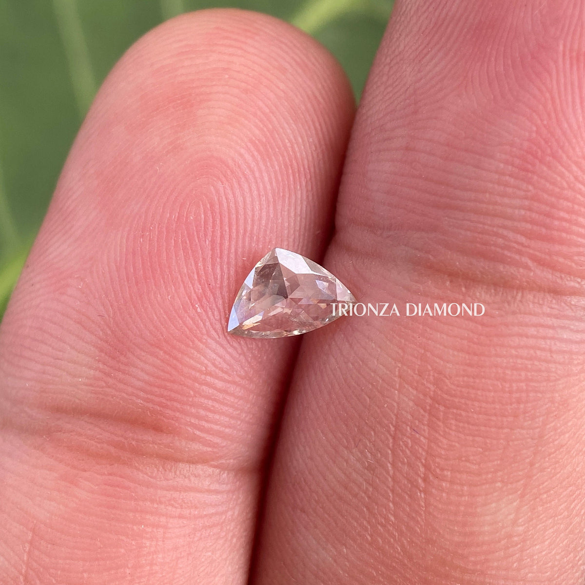 TrionzaDiamond curve trillion cut diamond presented as a side stone option for custom bridal rings
