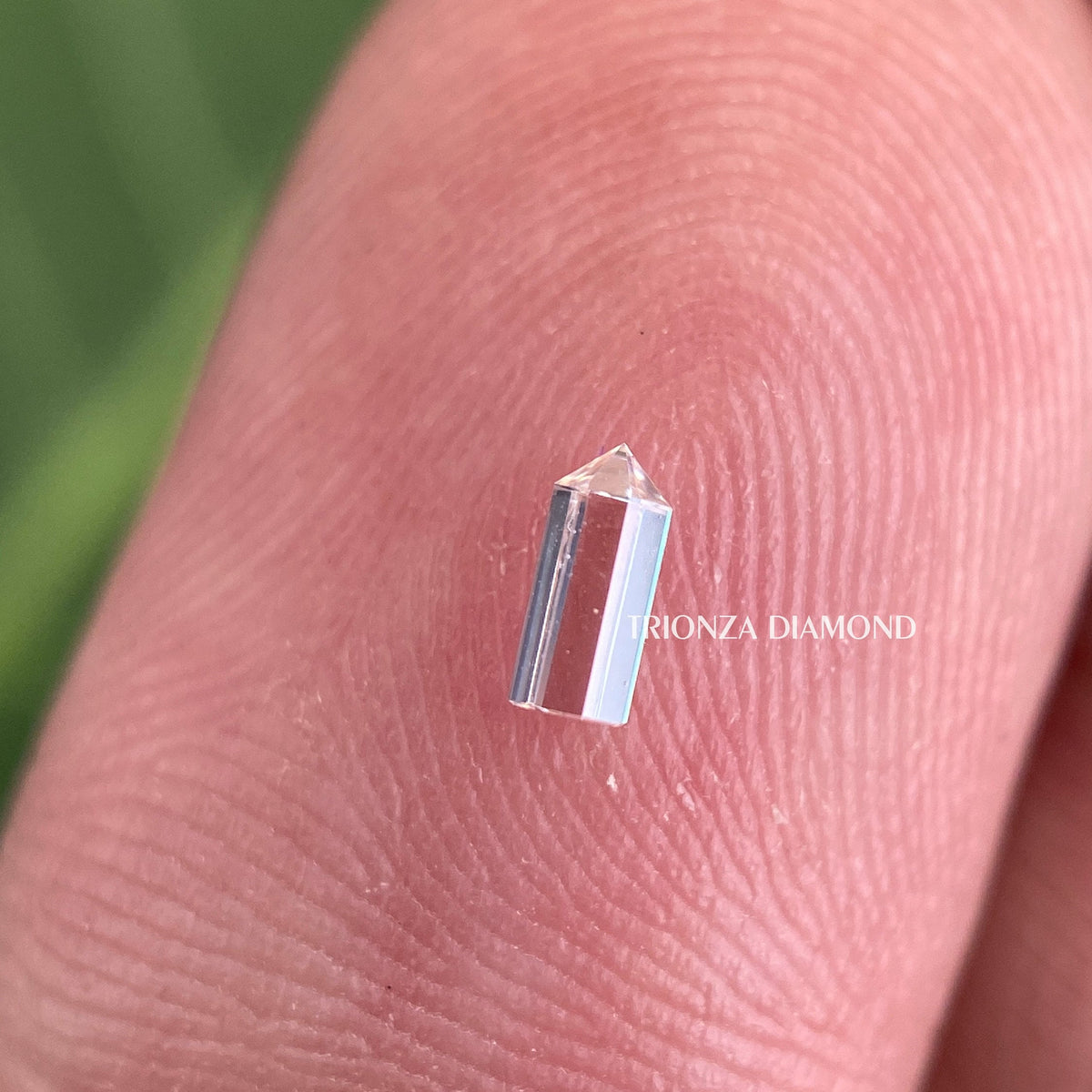Lab grown diamond positioned to highlight its 0.13 CT size and clarity details