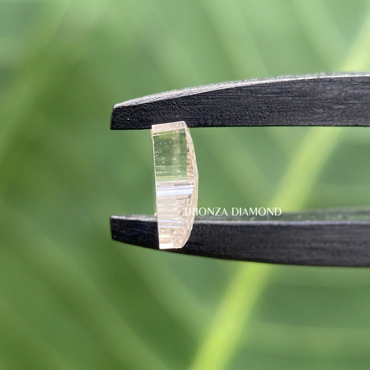 Lab grown diamond in butterfly cut shown from an angle to reveal its faceted polish