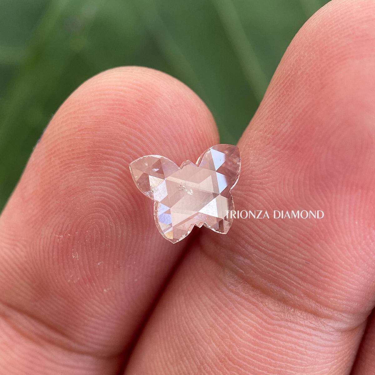 Loose butterfly cut lab grown diamond presented as a side stone option for engagement rings