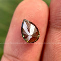 Loose pear cut fancy color diamond measuring 9 by 7 millimeters for custom jewelry design