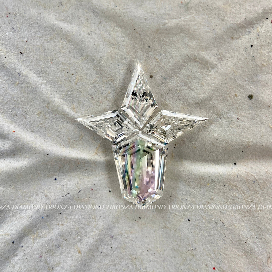 Kite cut star pendant featuring four loose lab grown diamonds arranged in a unique star shape