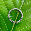 Full eternity band with 1.50 mm round moissanite stones set in a minimalist design