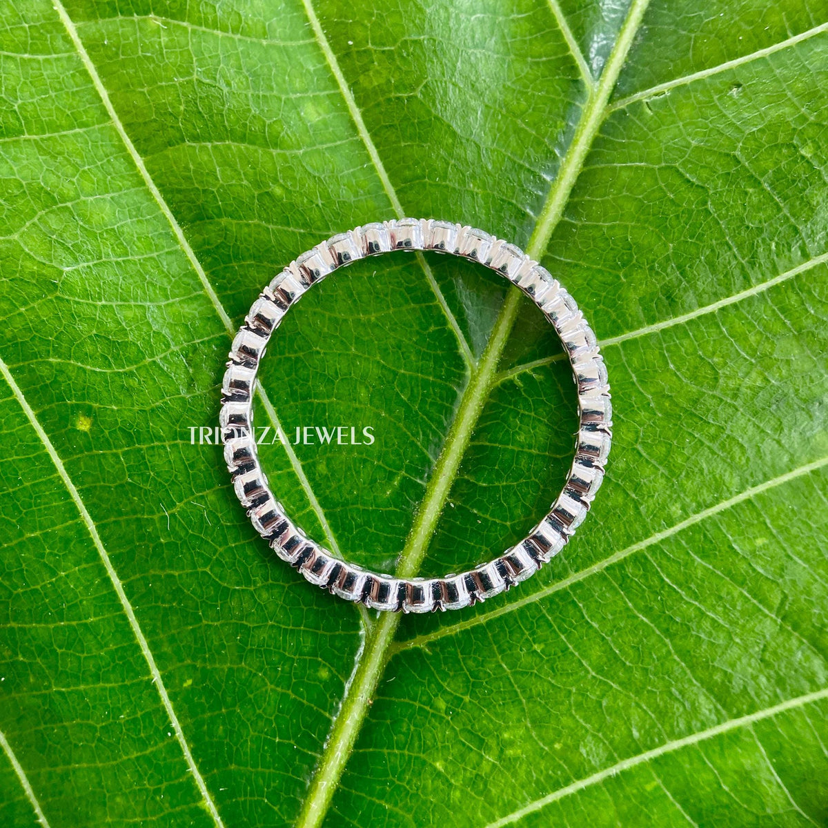 Full eternity band with 1.50 mm round moissanite stones set in a minimalist design