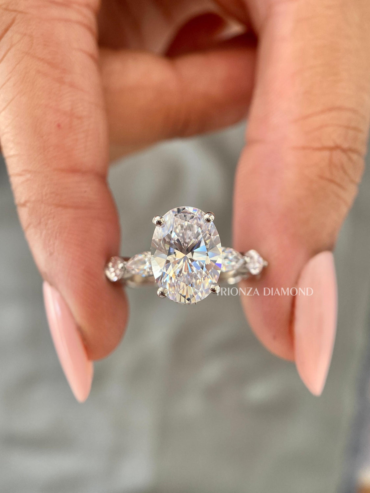 Woman wearing the oval diamond ring, highlighting its sparkle and modern bridal style