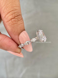 Hidden halo ring showcasing the 3 CT oval diamond paired with marquise side stones