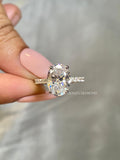 Hidden halo ring design featuring round brilliant cut side diamonds along the band