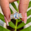 Handmade emerald cut engagement ring showcasing prong set moissanite stones in fine detail