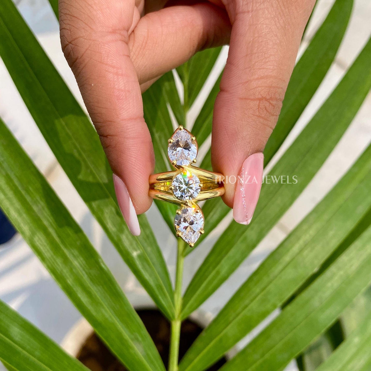 Vintage art deco engagement ring featuring a pear and round cut moissanite center stone