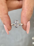 Cathedral style engagement ring showcasing the D color VVS2 clarity oval diamond