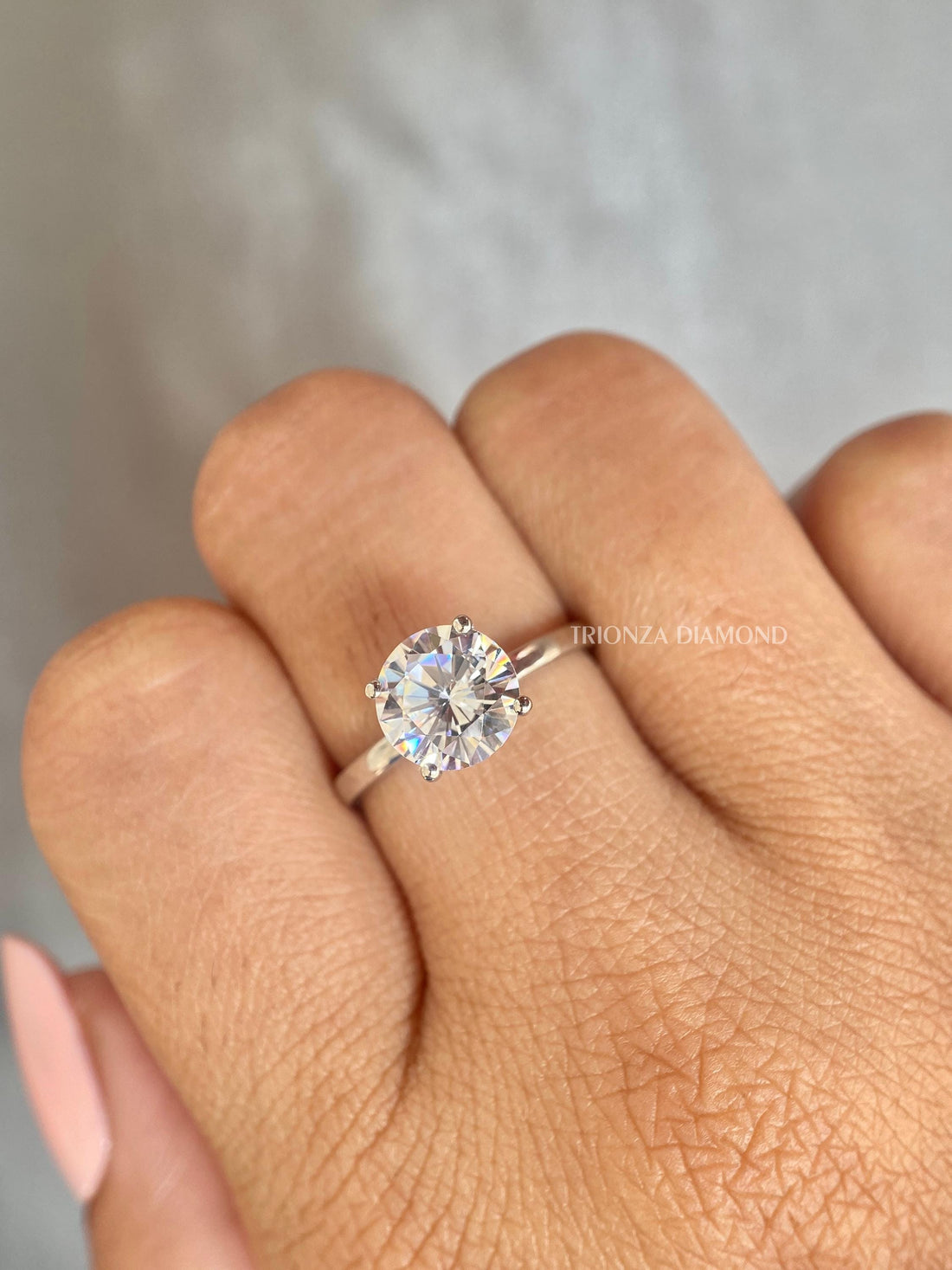 Round cut lab grown diamond solitaire ring featuring a 2 CT E/VVS center stone