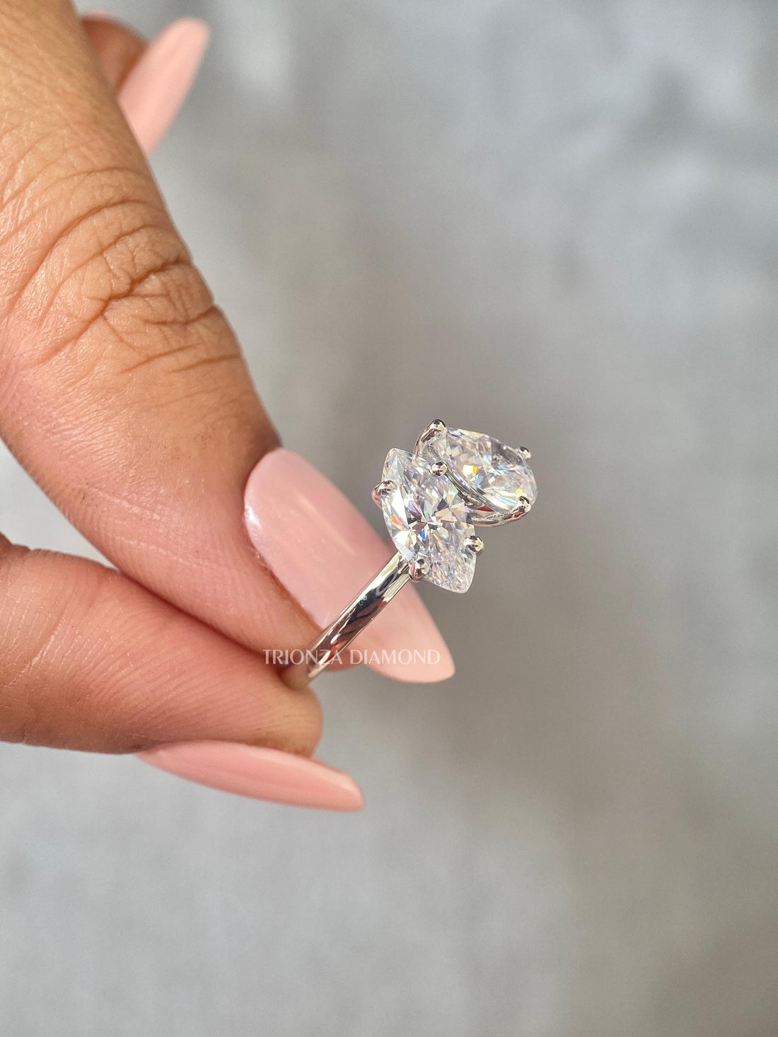 Toi et moi ring featuring a marquise cut and pear cut lab grown diamond set side by side
