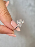 Close-up of the two-stone diamond ring showing the marquise and pear cut stones in detail
