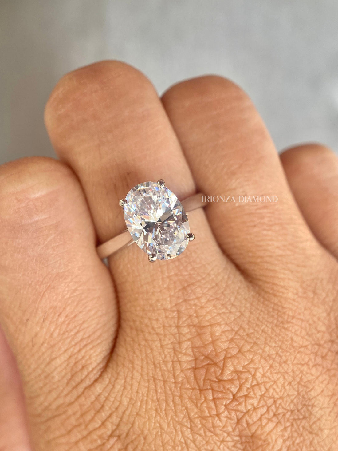 Oval lab grown diamond engagement ring featuring a classic 4 prong solitaire setting