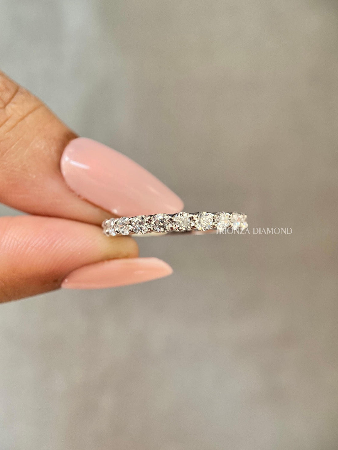 Pave half eternity wedding band featuring round cut lab grown diamonds set in 14k gold