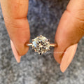 Woman wearing the round diamond solitaire ring, showcasing its brilliance on the hand