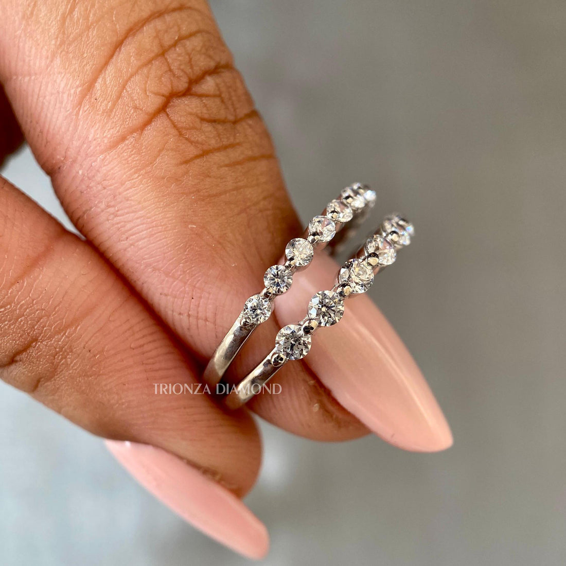 Floating bubble half eternity wedding band featuring round cut lab grown diamonds in a single prong setting