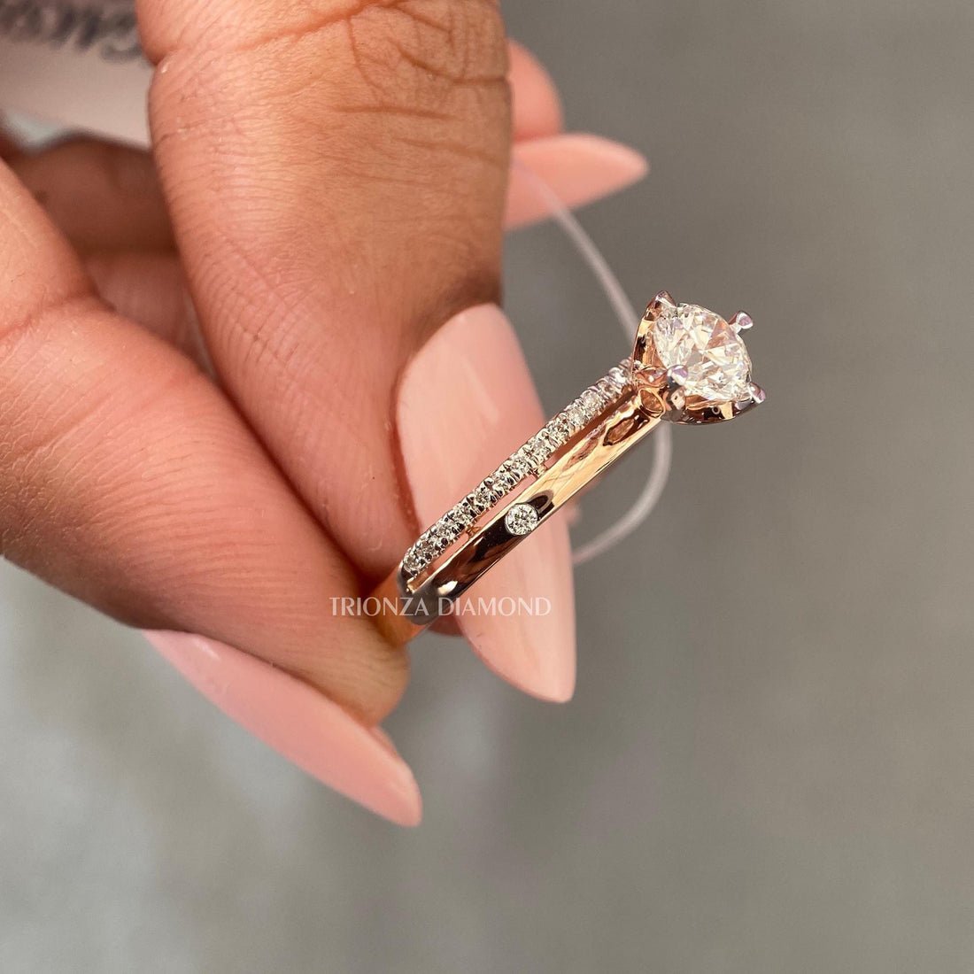Round cut lab grown diamond tulip engagement ring paired with a matching wedding band in 14K yellow gold