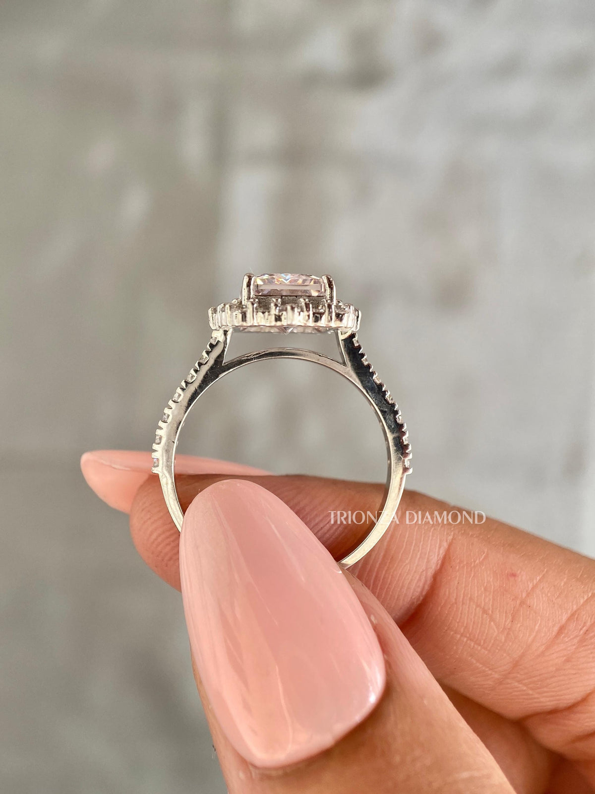 Close-up of the 2.50 CT E/VS1 radiant diamond set within a sparkling halo design
