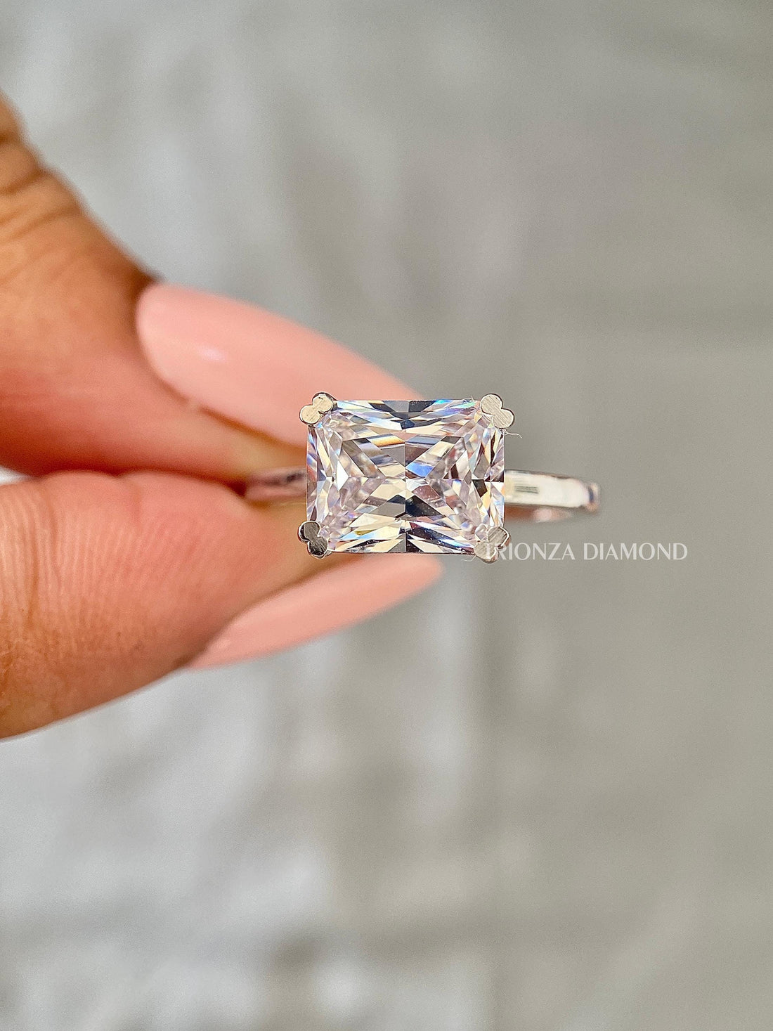 East West radiant cut lab grown diamond ring in 14K gold with a comfort fit band