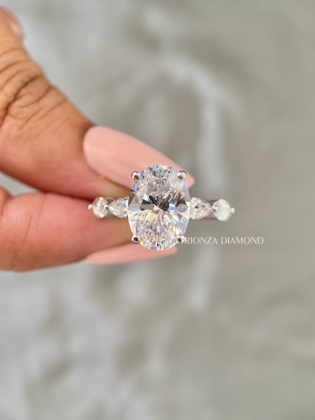Close-up of the F/VVS2 certified oval diamond set in a sleek solitaire design