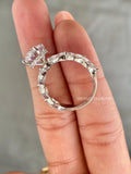 Marquise accent diamonds framing the oval center stone in a clean bridal silhouette