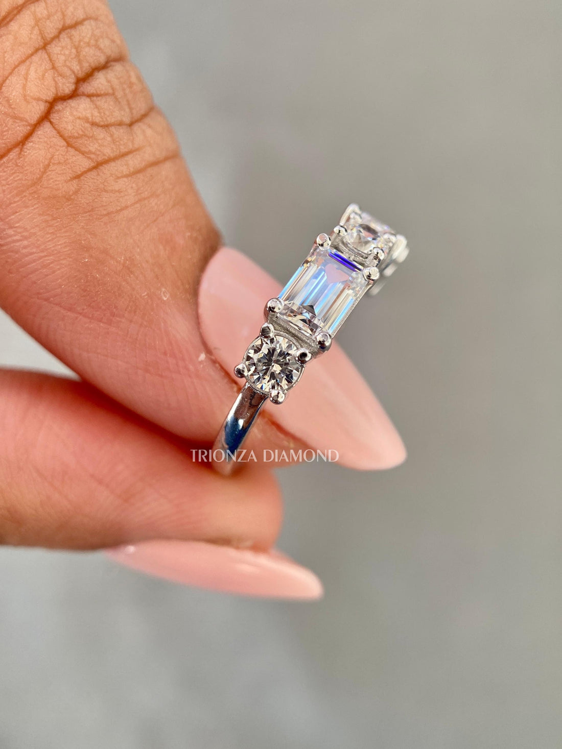 Emerald cut half eternity band featuring round and emerald cut lab grown diamonds in a gold setting