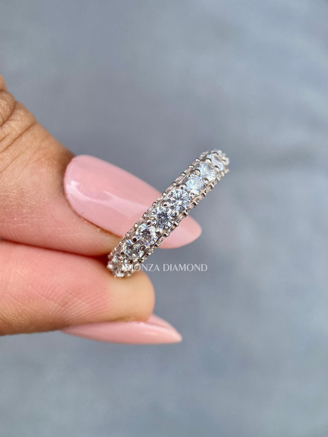 Round lab grown diamond eternity band in 14k white gold with chunky 3-sided pave setting